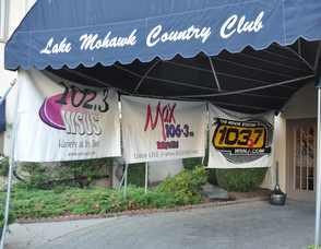 The entrance to the Lake Mohawk Country Club, with the Clear Channel station signs.
