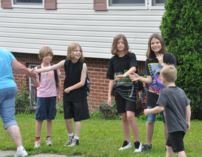 Children give high-fives to walkers along the route.