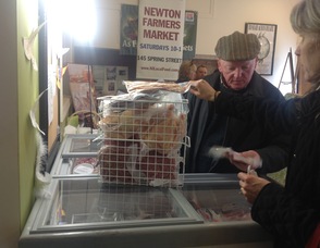 Wendy Miller purchases a pork chop, and other items, from Pat Kelly of Glenmalure Farm.