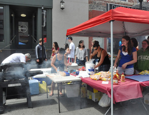 Newton High School Class of 2015 prepares hot dogs and burgers for the hungry crowd.