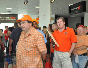 Fans dressed in orange Dukes of Hazzard wear, wait to meet the star.