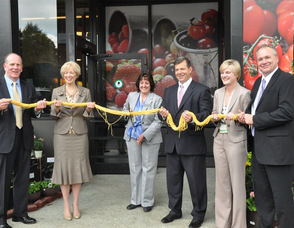 General Store Manager Carole Bracaglia cuts the "ribbon" of spaghetti, inviting shoppers to the new kings Food Market in Livingston.