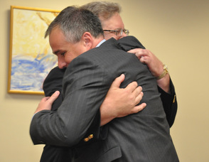 Wayne Dietz hugs Commissioner of the State Department of Labor and Workforce Development, Harold Wirths.