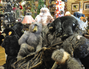Large stuffed animals cuddle up together on the couch, as customers browse.