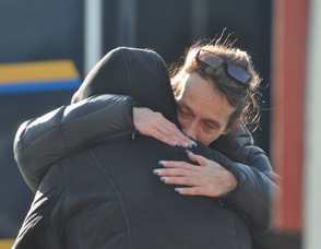 Two women embrace on the scene.
