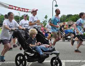 Some runners pushing baby strollers in the 5K.