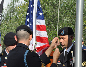 Matthew D. Neuenfeldt, John Flynn, and Juan Maldonado raise the American Flag.
