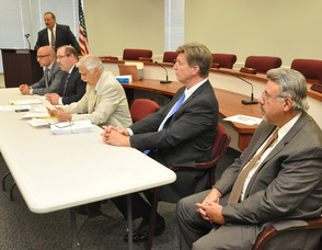 Sussex County Administrator John Eskilson listens to the auction terms.