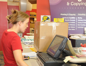 Wendy Asplund helps a customer with a shipping quote.