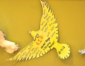 A paper dove with the names of all the victims of the Dec. 14 shooting posted on it, and hanging in the entry foyer of The Springboard Shoppes in Newton, N.J.