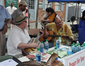 Members of Living Waters Fellowship give out water, pray with those who stop by, and entertain with music.
