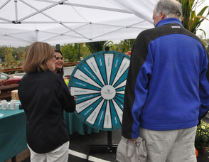 Event-goers take a chance on the prize wheel; a prize was given out with every spin.