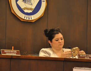 Mayor Helen Le Frois examines a piece of wood damaged by an Asian Longhorned Beetle.