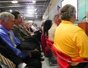 The crowd listens to Jennifer Jean Miller during the launch event.