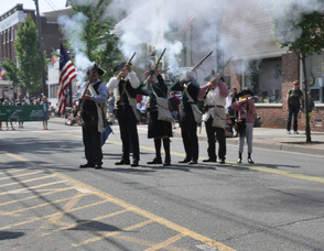 Revolutionary War Soldiers fire rifles into the air.