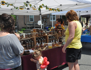 Visitors to the Spring Festival sample some jams.