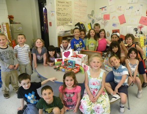 Students in Carole Grube's class smile with a care package.