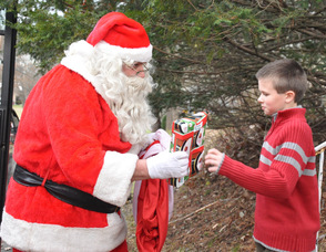 Edward Holder, age 10, receives his gift from Santa.