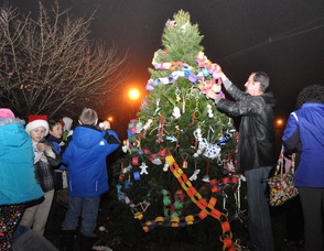 Residents place ornaments on the tree.