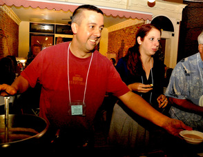 Tim Harder dishes out Butternut Squash Soup, while Jamie Harder serves "Grandma's Pie", a specialty pizza made by their restaurant, Pizza Bistro.