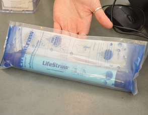 Justine Berg of Shelter Vintage, holds up a LifeStraw.