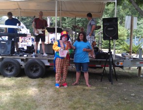 Clown reads off a winning raffle ticket number to the residents.