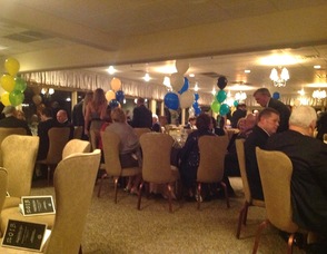 Attendees gather in the dining room to enjoy the festivities.