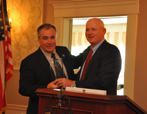 Chuck Roberts presents the award to Commissioner Hal Wirths for Business Advocacy.