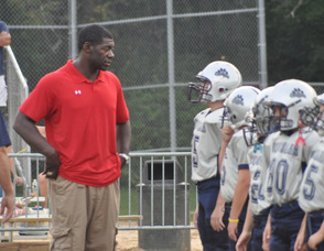 Roman Oben speaks to players before the game.
