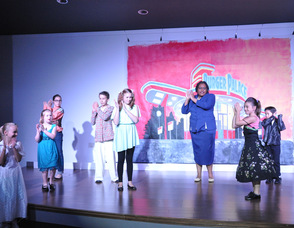 The actors and actresses dance "The Hand Jive".