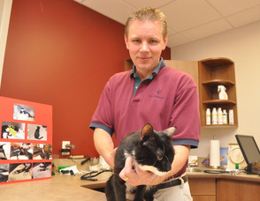 Dr. Harvey Hummel with Sparky in the examining room.