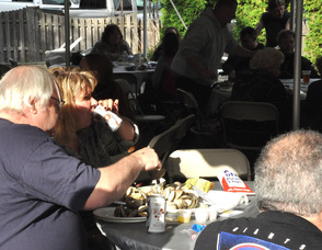 A couple with clams piled on their plates.