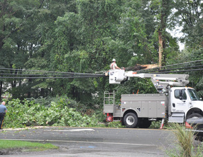 Sparta Township Police Officer Brian Hassloch directs traffic on Sparta Avenue in Sparta while JCP&L cuts a large tree limb off of a wire.