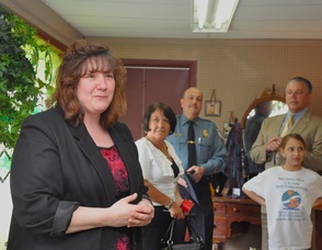 Rae Ann Martin, owner of Blooms of Elegance, introduces herself to guests at her grand opening.