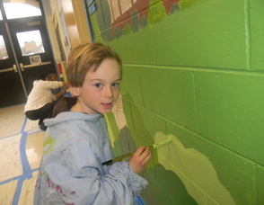 A student painting the mural