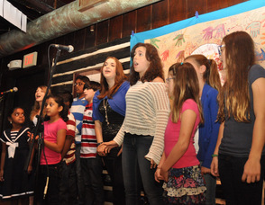 Students from the Birykov Academy sing as a group.