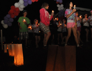 Luminarias in the foreground guide participants.