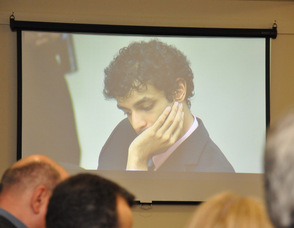 Dharum Ravi looks down as the Clementi family speaks.