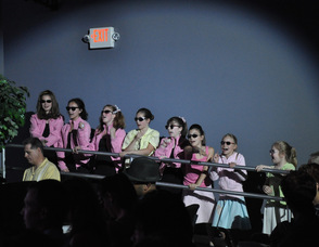 The female performers dancing to "Greased Lightning".