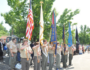 Local Boy Scouts hold the flags during the ceremony.