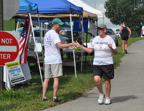 Mary Emilius gives a high-five to Tom Sweeney.