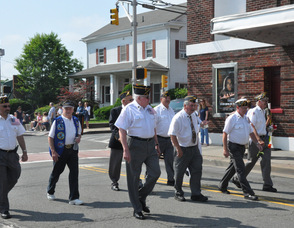 Local veterans march by the Newton Theatre.