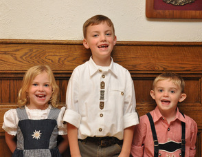 The Koster children, Erika age 4, Patrick age 6, and Daniel 4, enjoy the festivities.