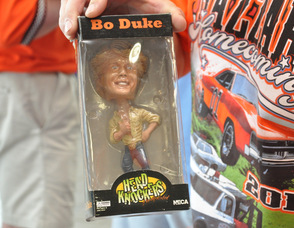 Brian Kapral holds up a Bo Duke Bobblehead.
