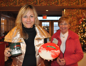 Sandra Meyer (left) holds up a plate and mug commissioned for the German Christmas Market, with mother Karin Meyer (right) in the background.