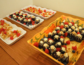 An array of dessert items interspersed with farm fresh berries.