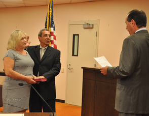 Joseph Ricciardo is sworn in as Deputy Mayor by Kevin Kelly, as Carol Wiley holds the Bible.
