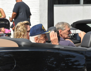 Lt. Colonel Henry Supchak, one of the parade Grand Marshalls, salutes the crowd.