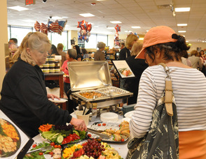 A customer opts to sample a gourmet sandwich.