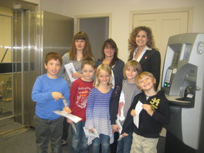 Debra Smorto (center) from Fields of Green Montessori School pictured with her students  from grades 1st -3rd and Sussex Bank’s Branch Manager Tracy Santangelo.